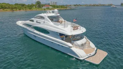 2004 Lazzara 106 Motor Yacht “Passion”: elevated stern-quarter view of motor yacht showing aft deck dining table and flybridge seating