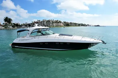 2005 Sea Ray 50 Sundancer “Nautical Dreamer”: side profile of navy-hulled express cruiser with oval portlights, long foredeck and bow rail