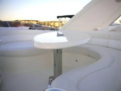 2006 Azimut 55 Flybridge: flybridge dinette with oval white table on stainless pedestal and curved cream seating