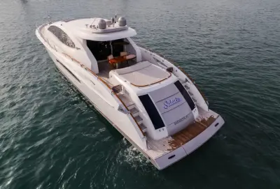 2007 Lazzara Yachts 75 LSX “Salacia”: elevated stern-quarter view of aft deck with sunpad, teak dining table and transom steps