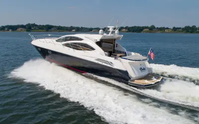 2010 Sunseeker 64 Predator “Bella”: stern-quarter view at speed showing open aft deck, teak swim platform and wide wake