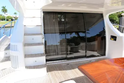2013 Azimut 64 Flybridge “Vivere”: aft cockpit with teak deck, flybridge stairs and sliding glass doors to salon