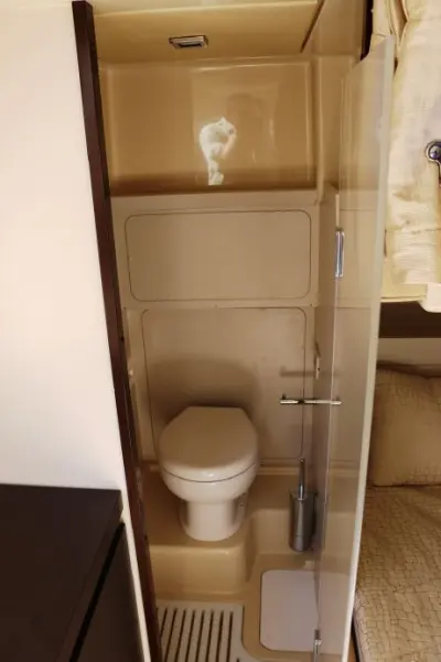 2013 Azimut 64 Flybridge “Vivere”: compact head with toilet, shower floor grate and glass door beside a bunk
