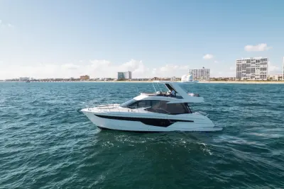 2020 Galeon 500 Fly “Livin the Dream”: flybridge motor yacht cruising offshore with guests at the upper helm under a white hardtop
