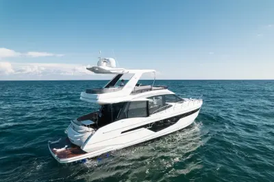 2020 Galeon 500 Fly “Livin the Dream”: stern-quarter view of flybridge yacht underway showing teak swim platform and aft cockpit