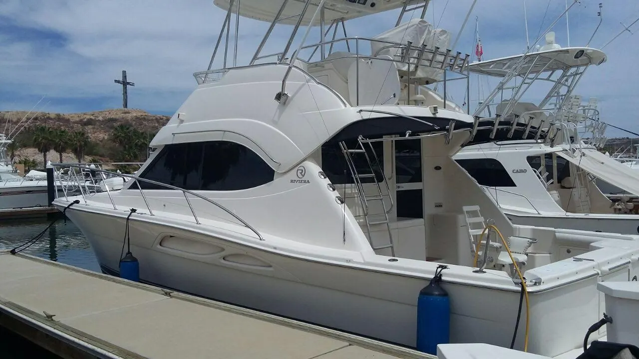 A sportfishing yacht with a tuna tower docked at a marina